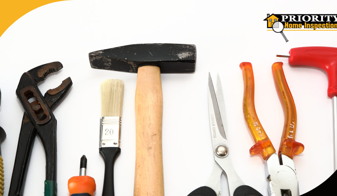 Assorted home inspection tools neatly arranged on a white background.