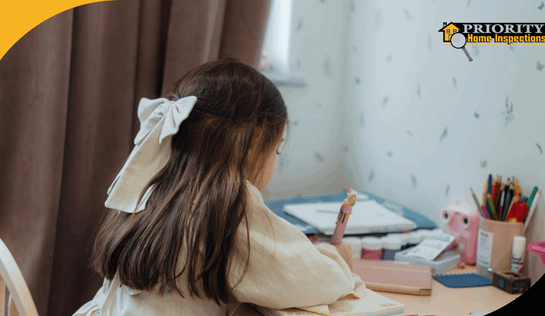 Young girl with a bow writing at a colorful desk in her room.