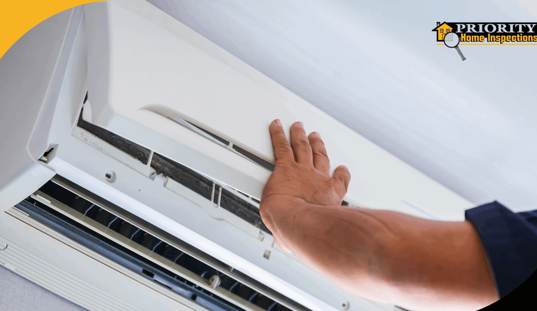 Hand inspecting an air conditioning unit.