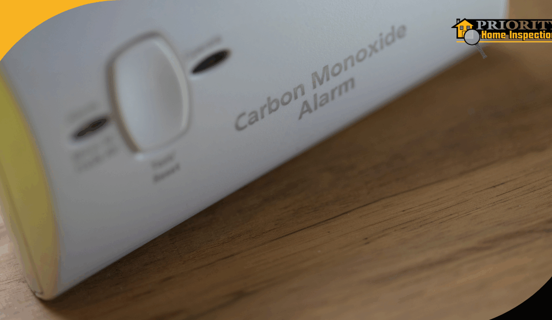Close-up of a carbon monoxide alarm on a wooden surface.